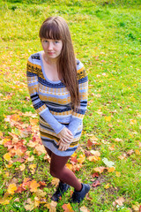 Girl on a walk in the autumn Park . Autumn park. Walk. Young girl.