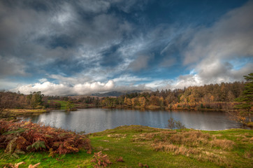Stunning landscape image of Tarn Hows in Lake District during beautiful Autumn Fall.