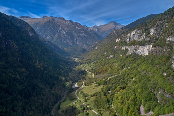 Naklejka na ściany i meble Autumn season, red-yellow trees. Aerial photography. Panoramic view of the Alps north of Italy. Trento Region. Great trip to the Alps.