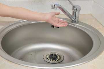 Little girl washes hands in the bathroom