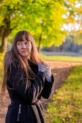 Fototapeta na wymiar Girl on a walk in the autumn Park . Autumn park. Walk. Young girl.