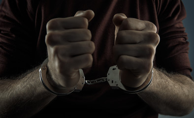handcuffed man; front view close-up
