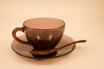 Cup with saucer and spoon on a light background