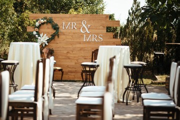 Mr & Mrs sign on wooden background at wedding reception.
