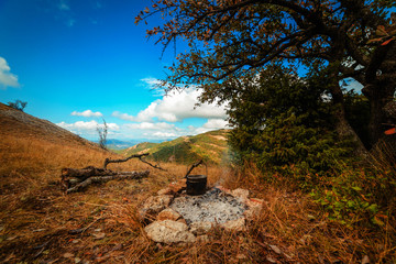 Bowler hat over a campfire in the fall