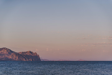 Mountain coast in the summer at sunset