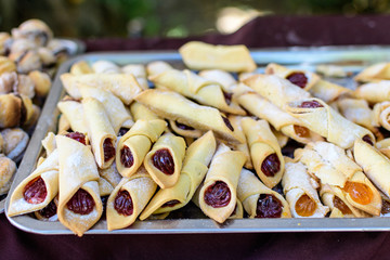 Traditional sweet Eastern Europe filling with apricot sweet jam, known as cornulete in Romanian language, displayed for sale at a street food market, soft focus