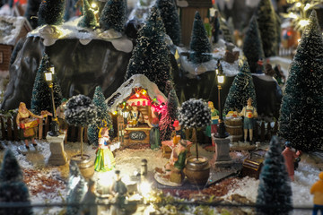 Miniature of Christmas scene old wooden house in forest, people, winter concept, Christmas holidays