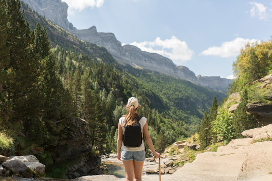 Rear view of woman enjoying the view in the mountains, Ordesa national park, Aragon, Spain