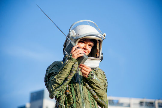 Boy wearing a space suit and using walkie talkie