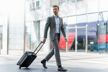 Businessman with baggage on the go