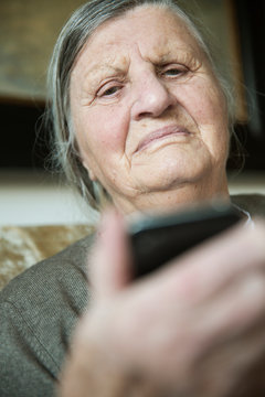 Portrait of senior woman holding smartphone