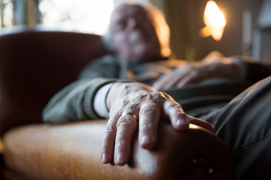 Senior Man Relaxing In Armchair, Detail