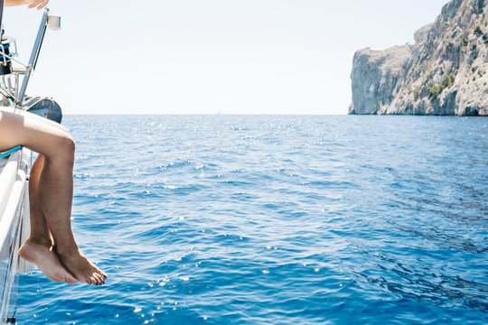 Spain, Mallorca, Woman sitting on sailing boat