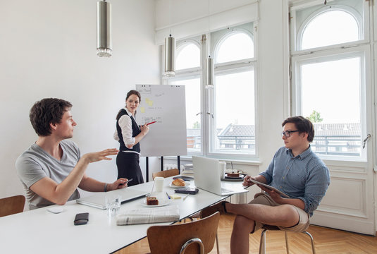 Three creative business people having a meeting in a modern office