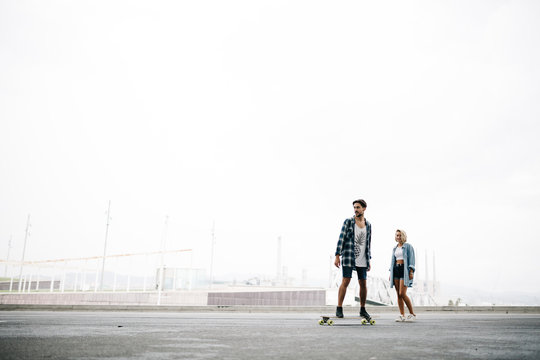 Friends longboarding in the street