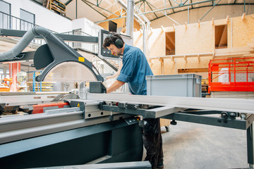 Carpenter working with saw in workshop