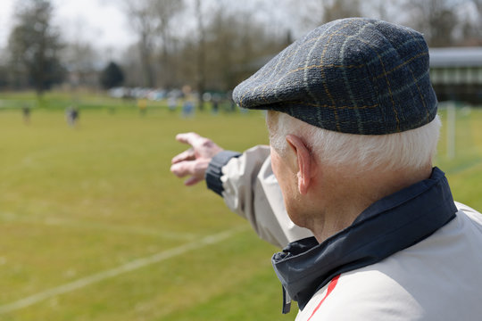 Old man watching football match