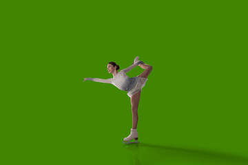 Figure skating girl isolated on green background.