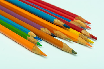 multicolored pencils made of rainbow color on a white background close-up