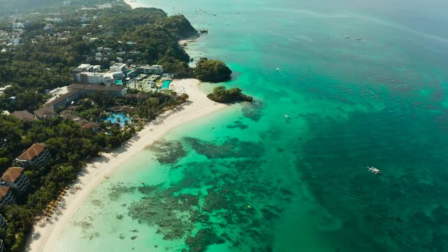 Tropical white sand beach, hotels near the blue lagoon and corall reef. aerial view, Boracay, Philippines. Seascape with beach on tropical island. Summer and travel vacation concept.