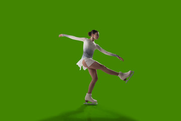 Figure skating girl isolated on green background.