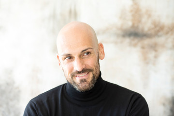 Portrait of smiling man wearing black turtleneck