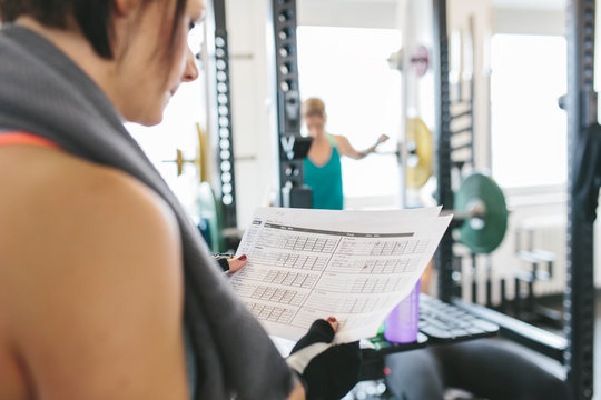 Woman checking her workout routine in gym