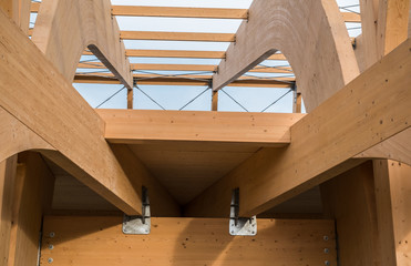 Detail of a modern wooden architecture in glued laminated timber on a blue cloudy sky - obrazy, fototapety, plakaty