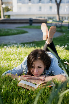 Young woman in park reading book