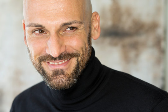 Portrait of smiling man wearing black turtleneck
