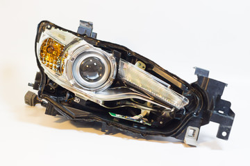 car headlight reflector block close-up on a white background. component parts of the machine. © Maria