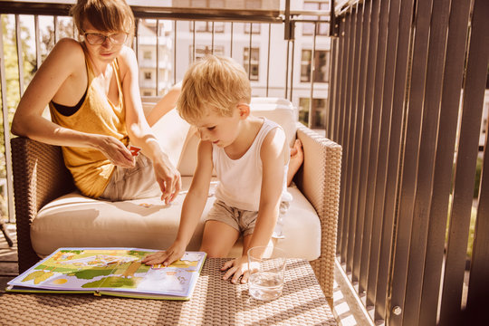 Mother and son together on balcony