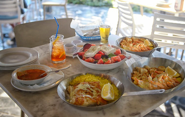 A summer  dinner .Unidentified people eating traditional delicious mediterranean dish  outdoor restaurant  in Cyprus , Ayia-napa.Tasty and authentic cypriot kitchen