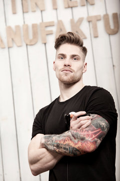Portrait of tattooist in his tattoo studio