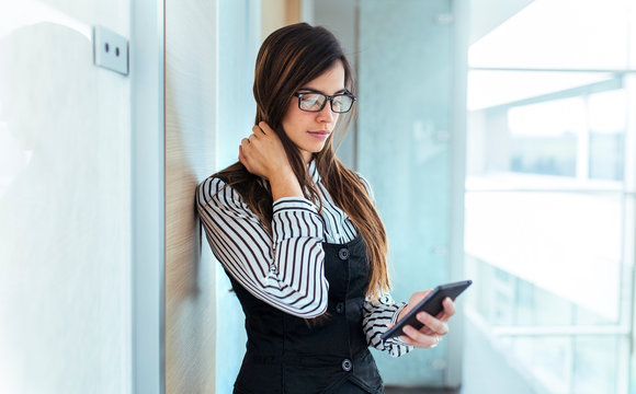 Young businesswoman looking at her smartphone