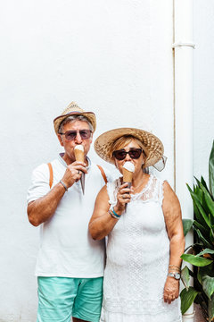 Senior tourist couple eating an ice cream