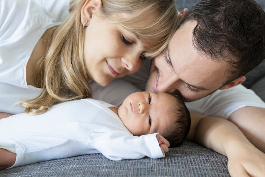 Young couple with newborn baby boy at home