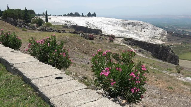 Pamukkale, Denizli, Turkey - 16th of July 2019: 4K Beautiful view on sinter terraces and valley
