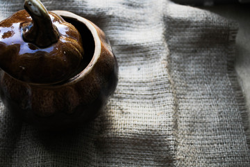 Pot with baked mushrooms on a piece of cloth
