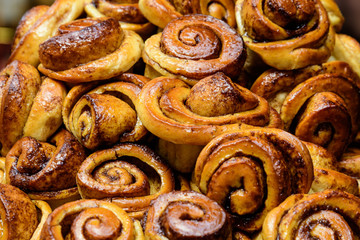 Freshly baked homemade English cinnamon rolls displayed for sale at a café in London, selective focus