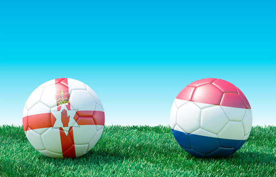 Two soccer balls in flags colors on green grass. Northern Ireland and Netherlands. EURO 2020. Group C. 3d image