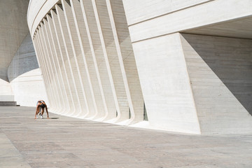 Pulled back view of female athlete in starting position