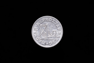 Old Hungarian 50 Filler coin from 1976, obverse showing Elisabeth Bridge in Budapest. Isolated on black background