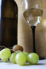 Bottle of wine, glass and grapes