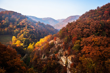 Autumn sunrise on mountain with fog between the hills. National park Djerdap in Serbia.