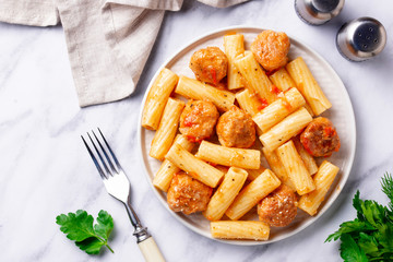 Pasta with meatballs in tomato sauce.