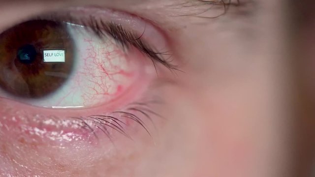 Words SELF LOVE reflected in Man's eye macro shot isolated