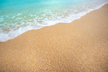 Fototapeta na wymiar Soft wave of blue ocean selective focus on sandy beach ,On sandy beach background. Travel concept