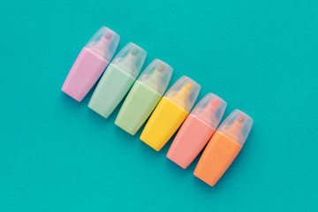 Highlighters set on colored green background. Collection of markers different color. Top view. Back...
